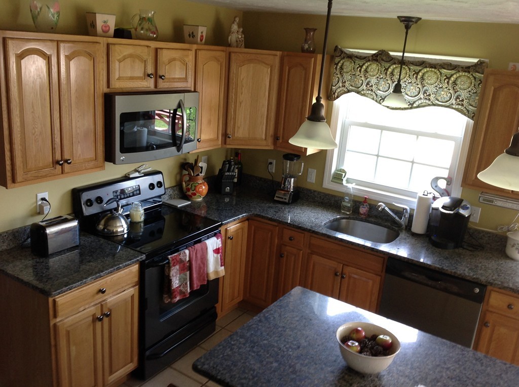 44 Tobin Road Leicester, MA 01611 - Photo 16 of 30 a kitchen with sink a stove and cabinets