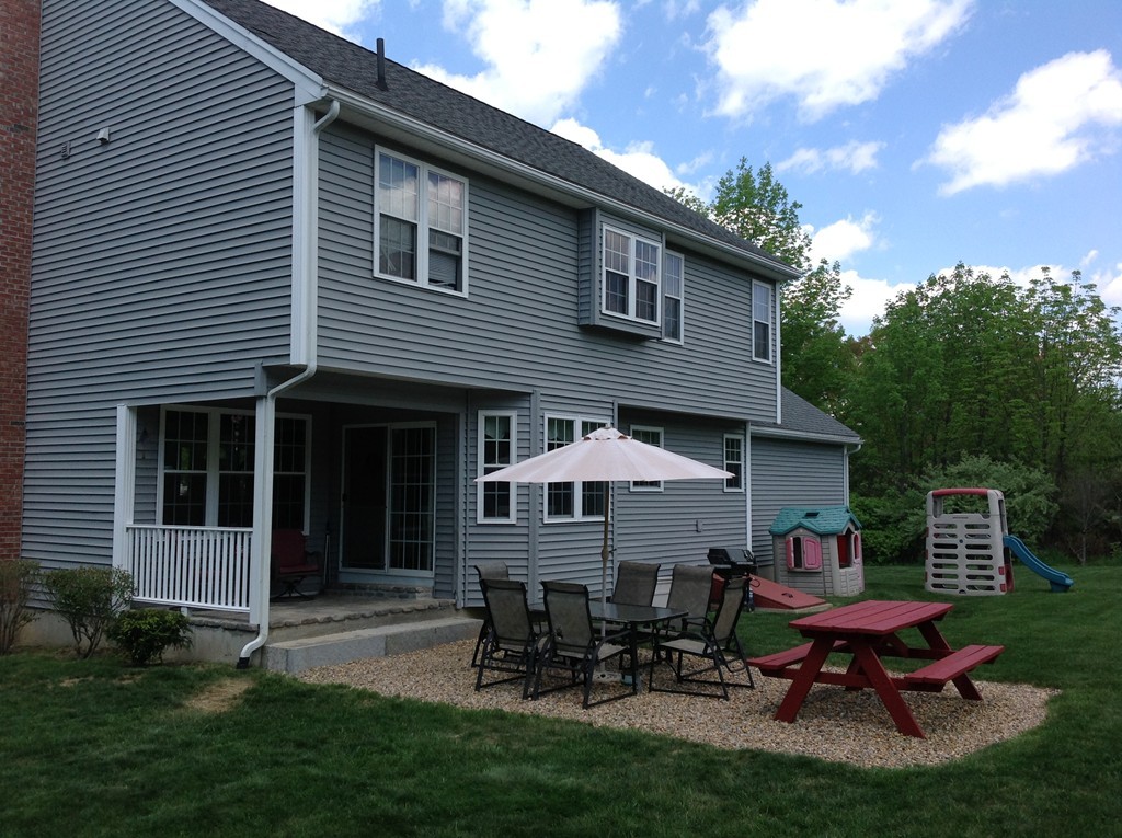 44 Tobin Road Leicester, MA 01611 - Photo 7 of 30 a backyard of a house with table and chairs