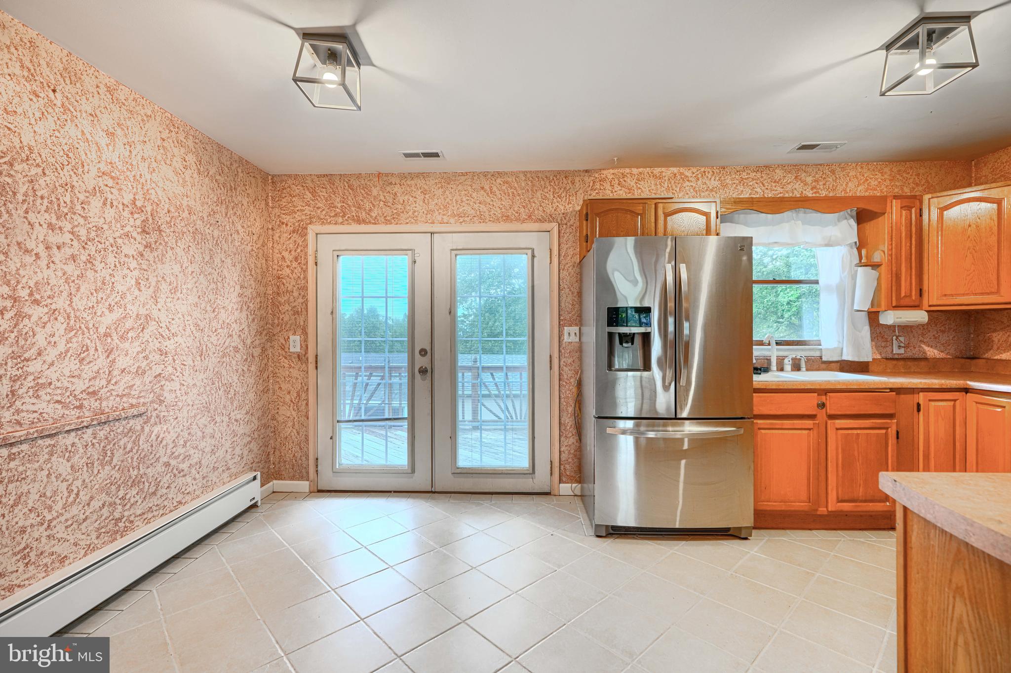 708 Gray Mt Circle Elkton, MD 21921 - Photo 16 of 59 a kitchen with stainless steel appliances granite countertop a refrigerator and a sink