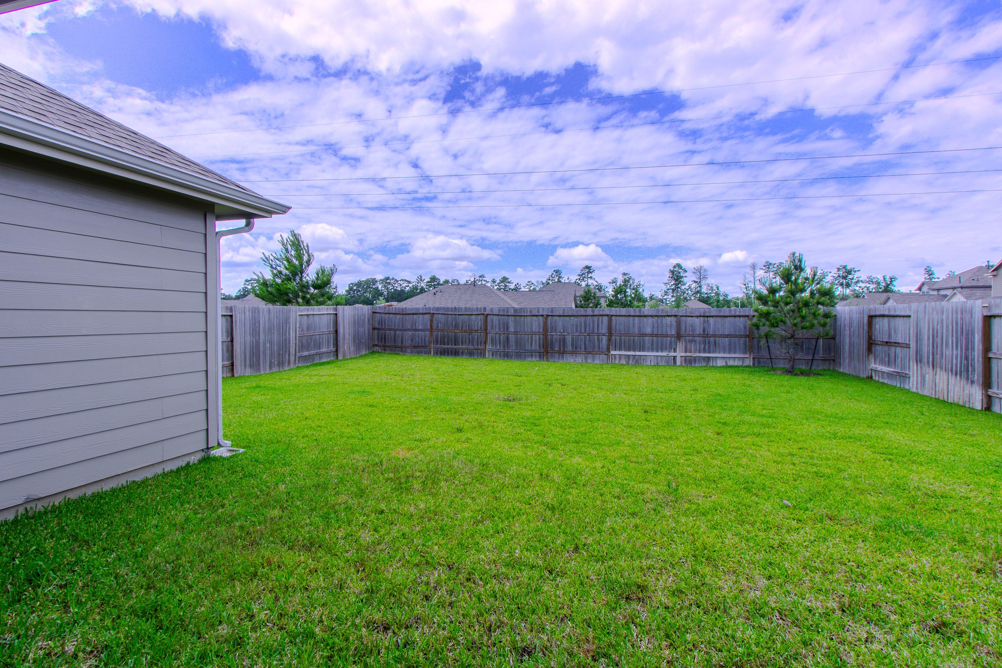 3113 Catalonion Court Conroe, TX 77301 - Photo 29 of 45 a view of yard with swimming pool and green space