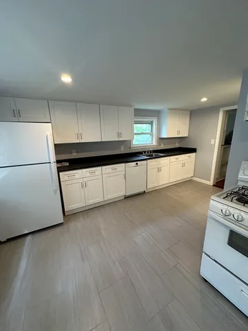 a view of a room with wooden floors and window