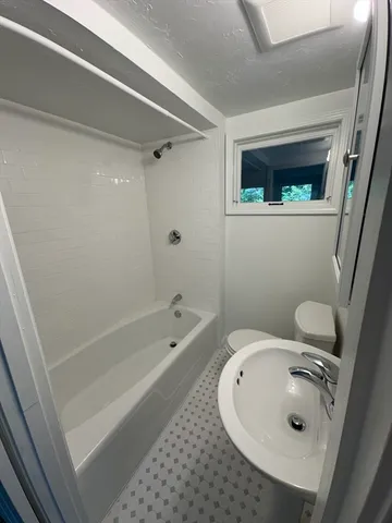 a kitchen with granite countertop a stove a sink and a microwave