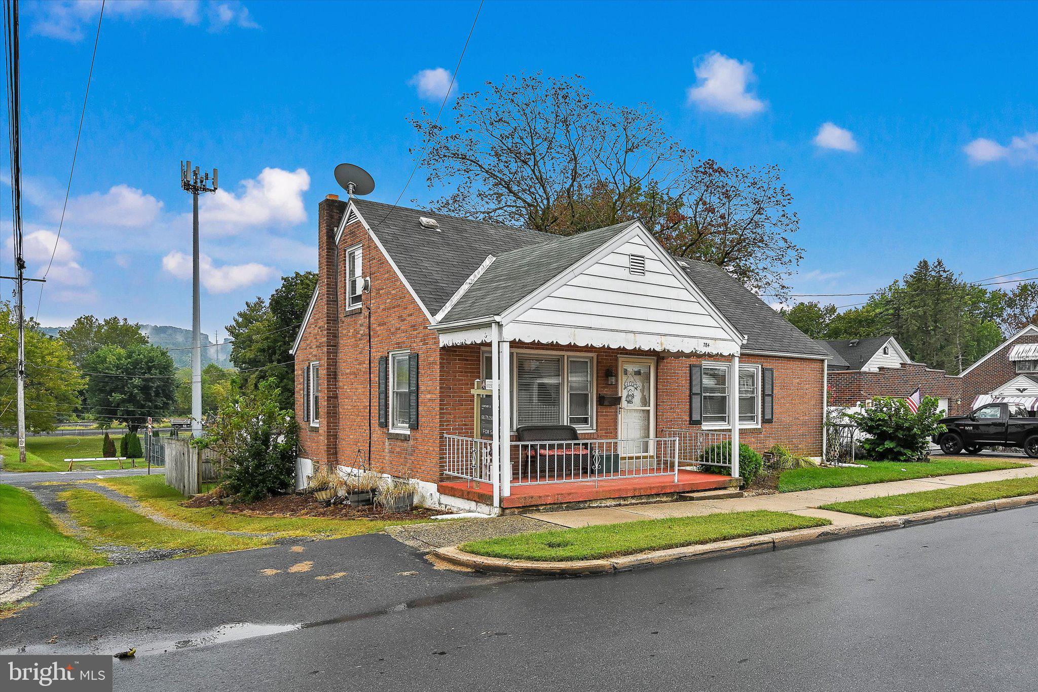 a front view of a house with a yard table and chairs