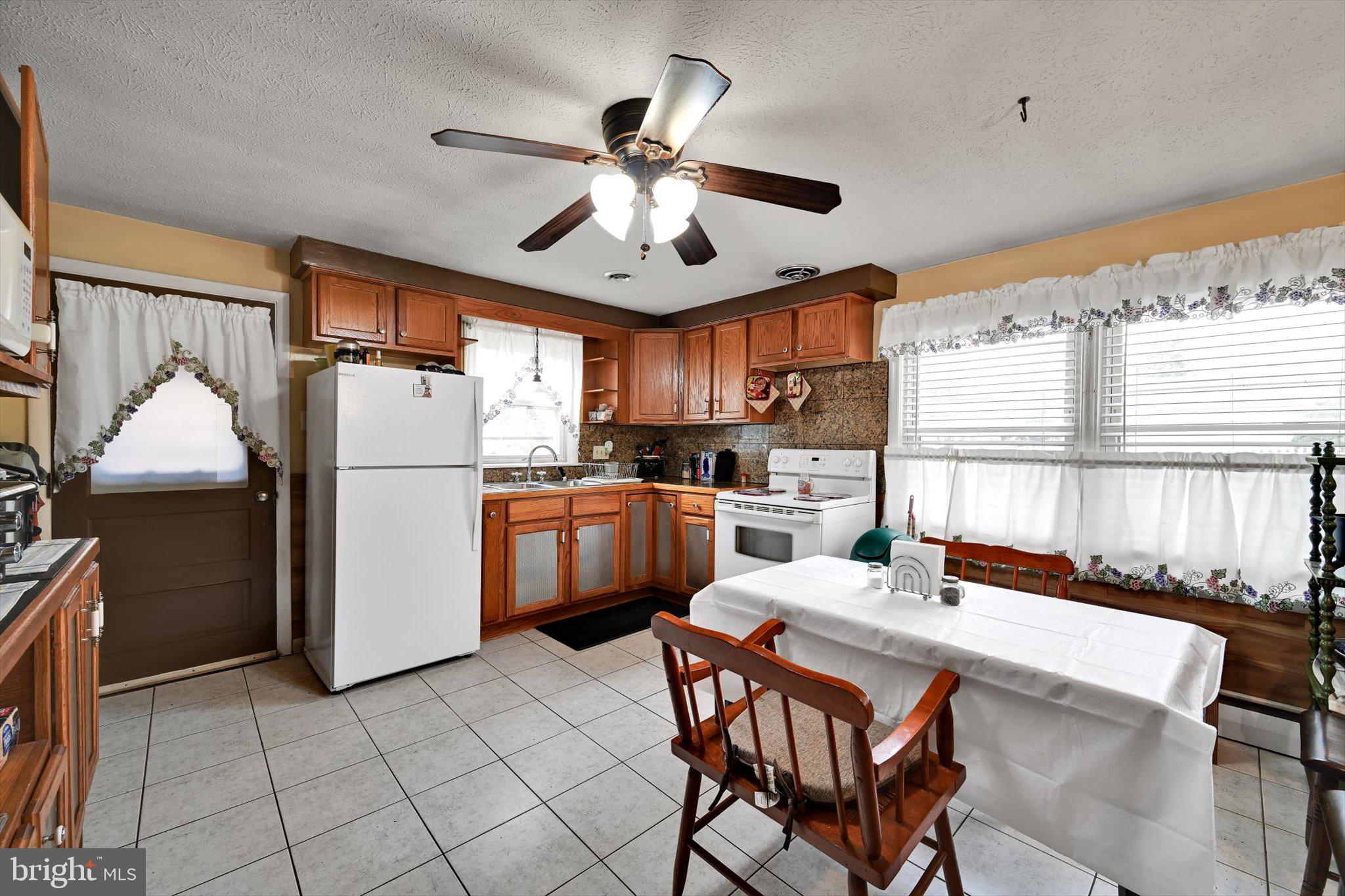 784 Ruth Street Sinking Spring, PA 19608 - Photo 4 of 27 a kitchen with furniture a window and stainless steel appliances