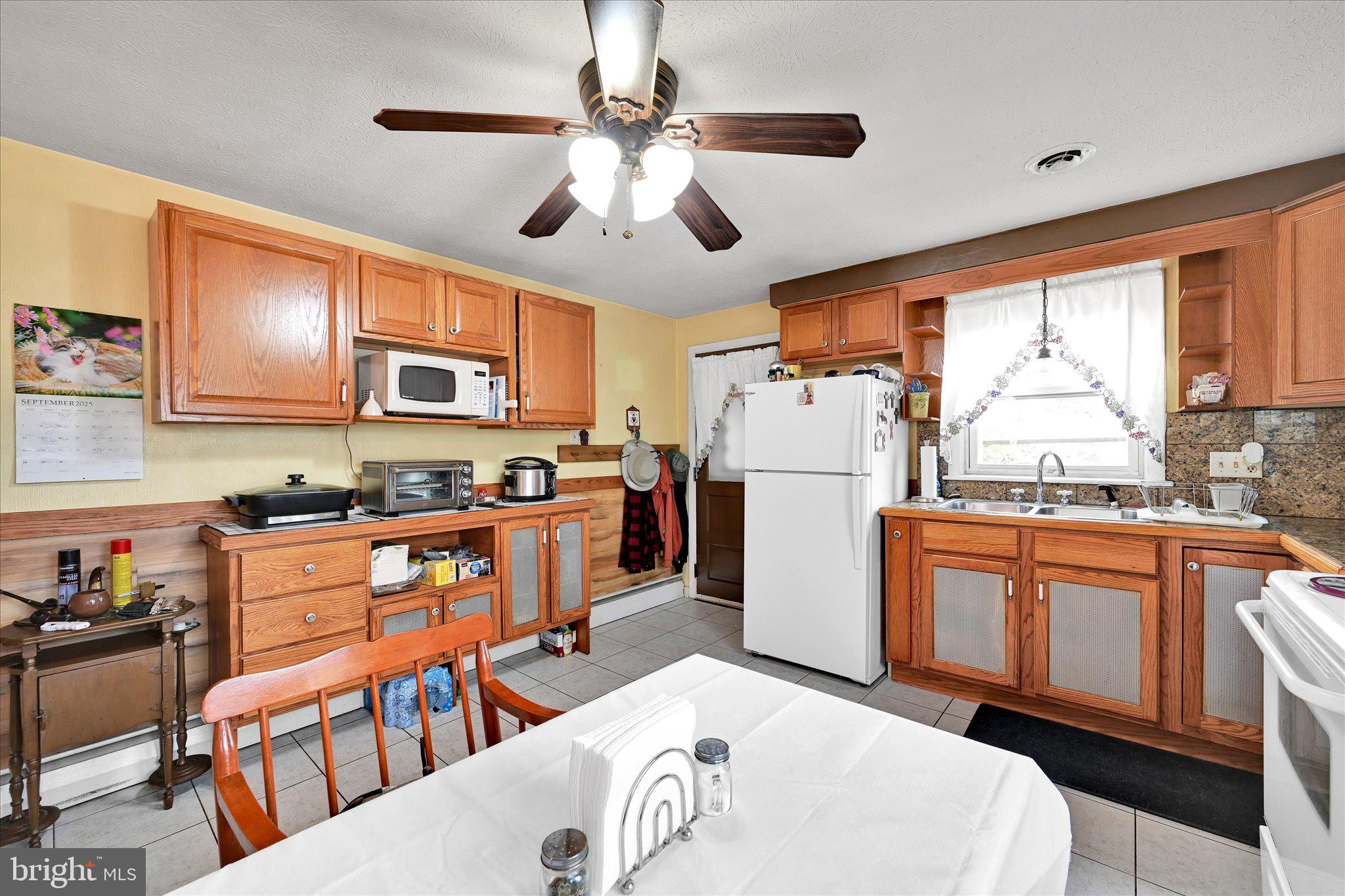 784 Ruth Street Sinking Spring, PA 19608 - Photo 7 of 27 a kitchen with stainless steel appliances granite countertop a refrigerator a stove top oven a sink dishwasher and white cabinets