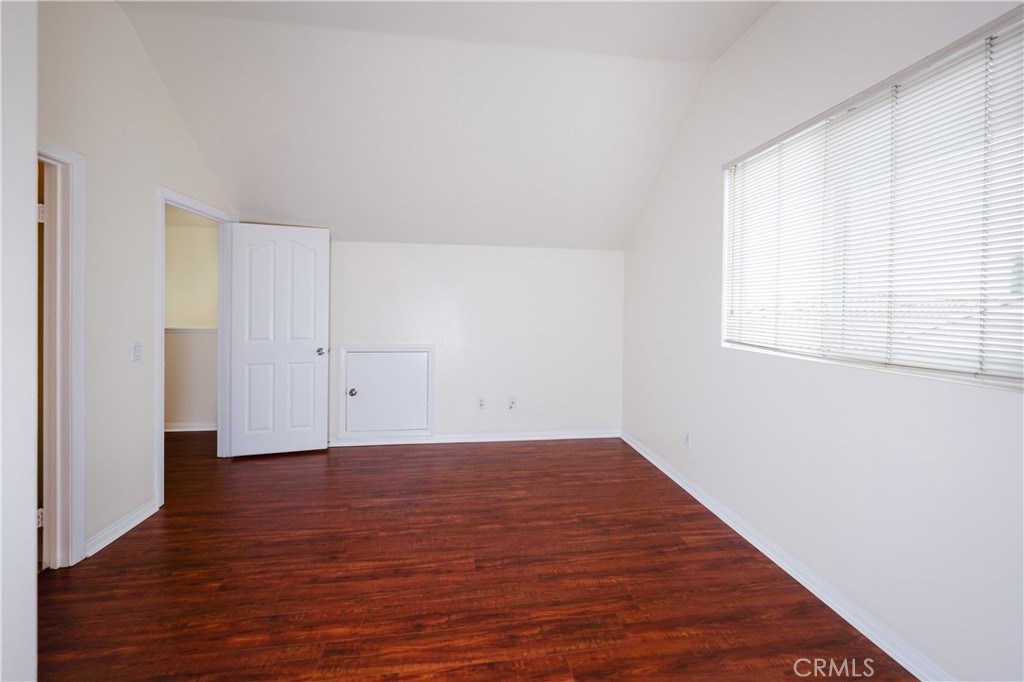 3663 Scribner Lane Inglewood, CA 90305 - Photo 14 of 18 an empty room with wooden floor and windows