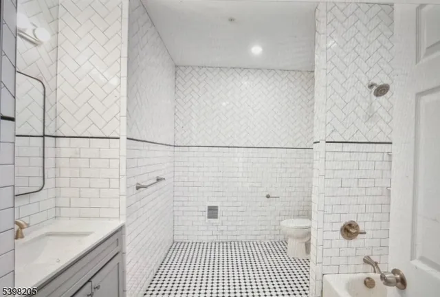 a bathroom with a sink a toilet a window and shower