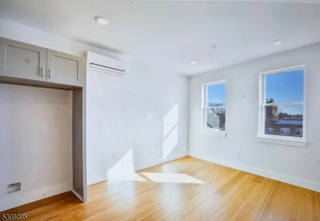 a view of a room with wooden floor and cabinet