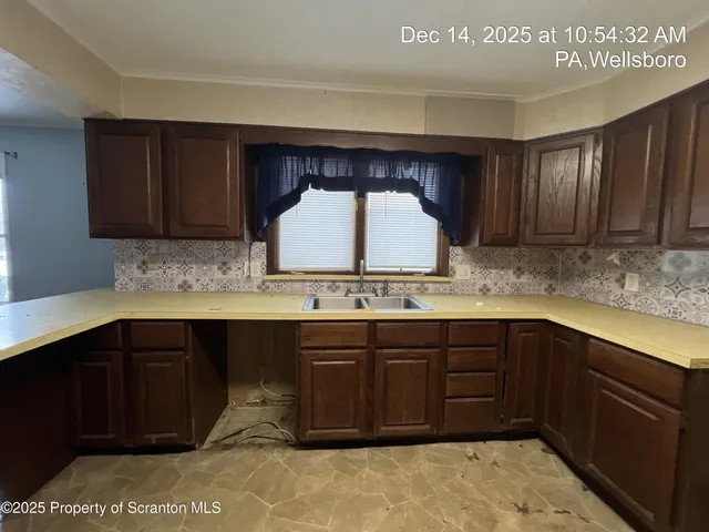 a kitchen with a sink and a stove top oven