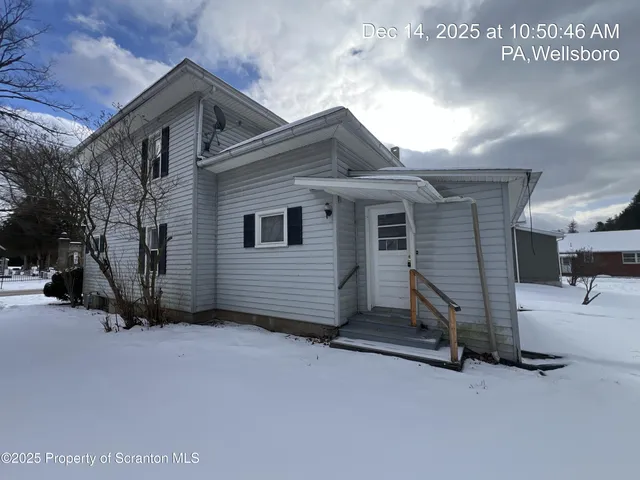 a view of a house with a parking space