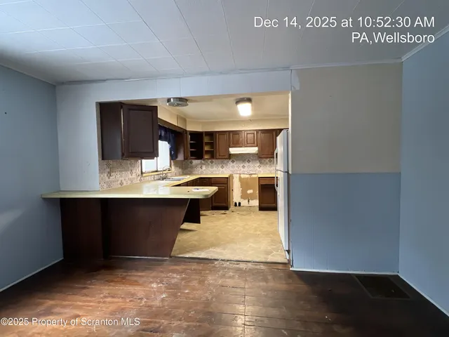 a living room with a sink furniture and a kitchen view