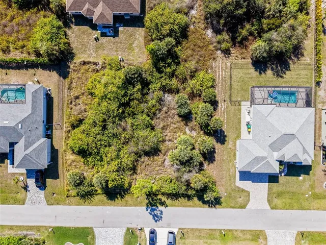 an aerial view of residential houses with outdoor space
