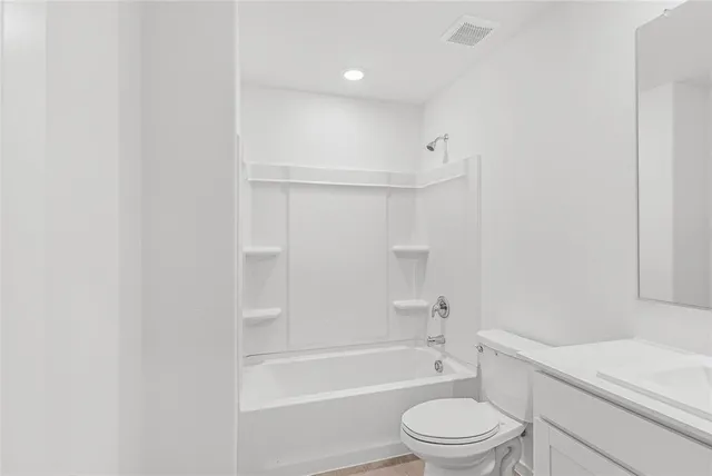 a bathroom with a toilet a sink and a bathtub