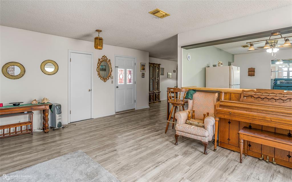 251 Tom Murphy Road Jamestown, LA 71045 - Photo 18 of 40 Living area featuring a textured ceiling, ceiling fan, and light wood finished floors
