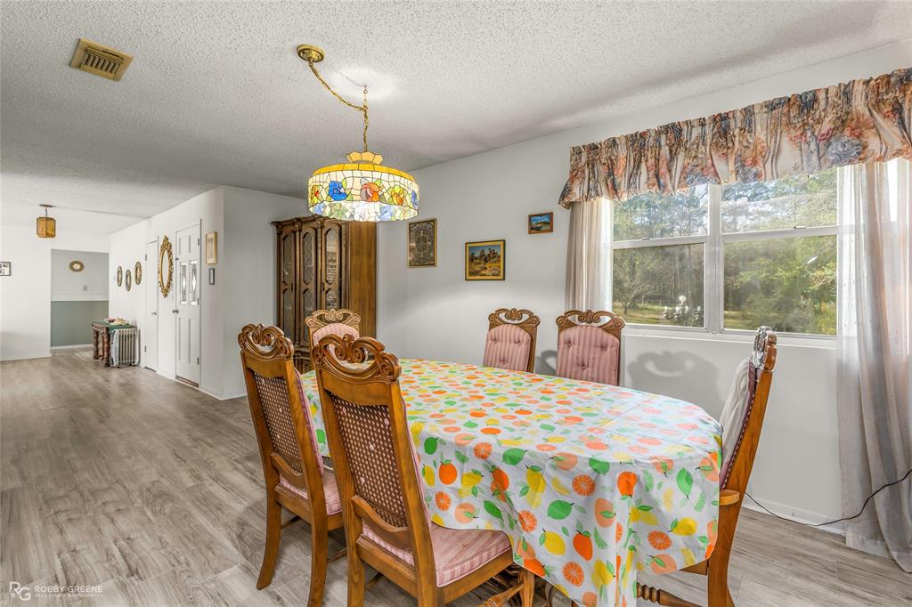 251 Tom Murphy Road Jamestown, LA 71045 - Photo 20 of 40 Dining area featuring light wood-style floors and a textured ceiling