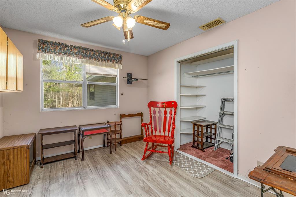 251 Tom Murphy Road Jamestown, LA 71045 - Photo 31 of 40 Sitting room featuring a textured ceiling, light wood-type flooring, and ceiling fan