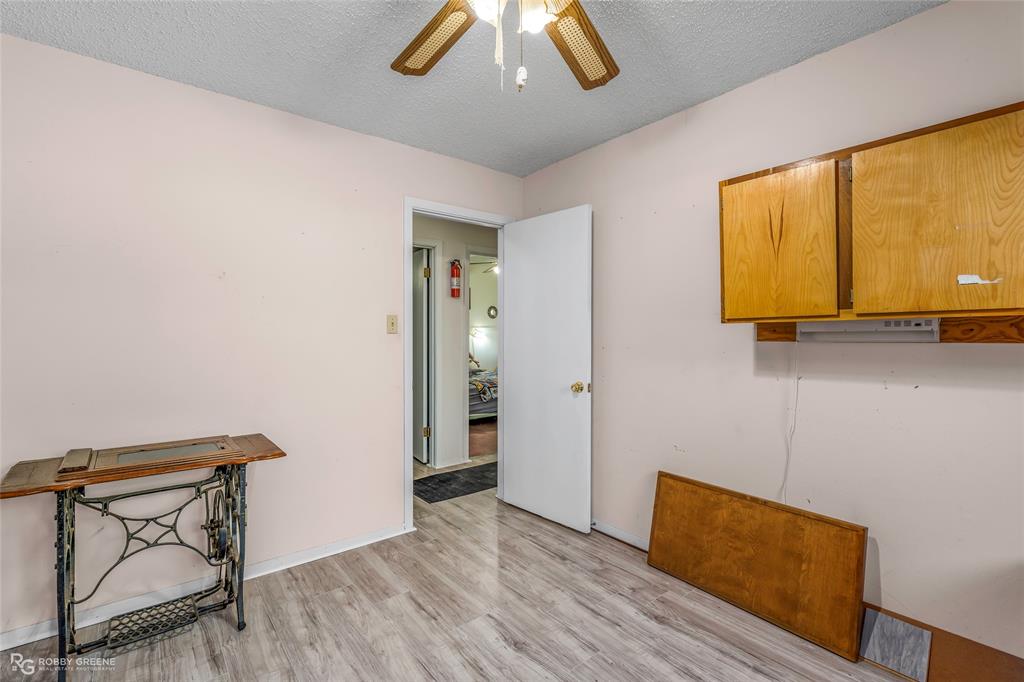 251 Tom Murphy Road Jamestown, LA 71045 - Photo 32 of 40 Unfurnished office featuring a ceiling fan, light wood-style flooring, and a textured ceiling