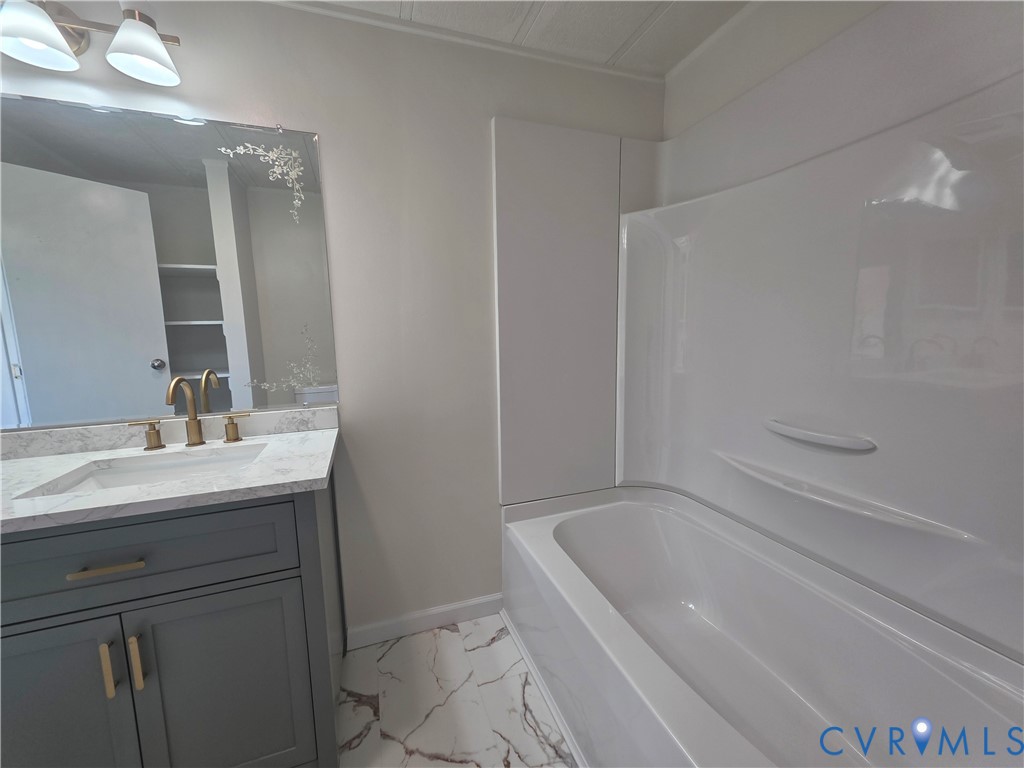 16808 Hamilton Arms Road Dewitt, VA 23840 - Photo 16 of 30 a bathroom with a sink a toilet and shower