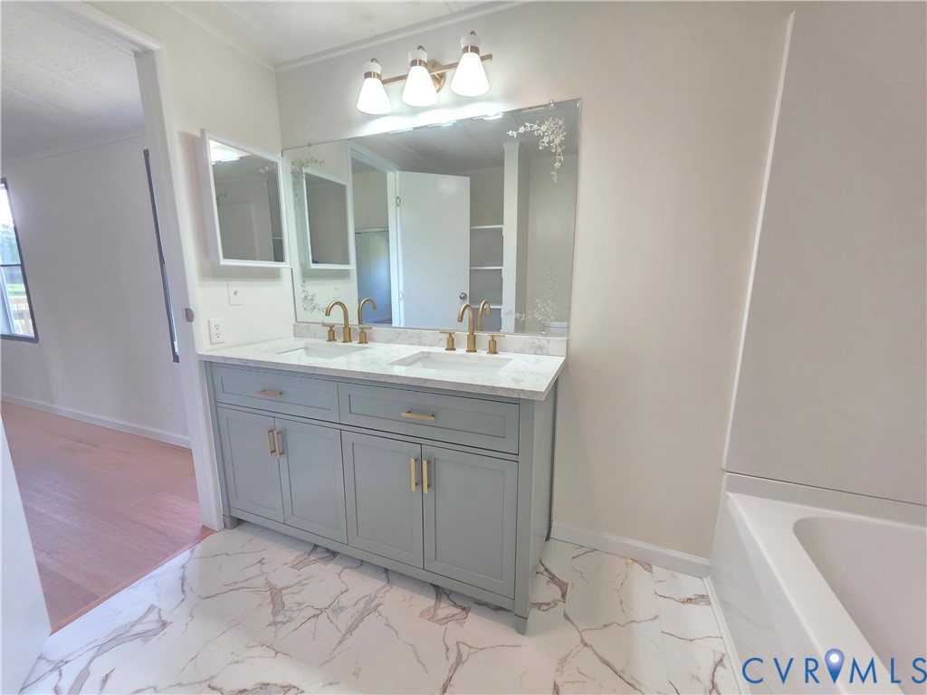 16808 Hamilton Arms Road Dewitt, VA 23840 - Photo 17 of 30 a bathroom with a sink and a mirror