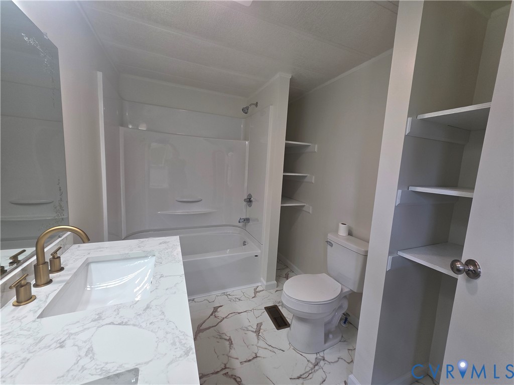 16808 Hamilton Arms Road Dewitt, VA 23840 - Photo 18 of 30 a bathroom with a sink a toilet and a tub