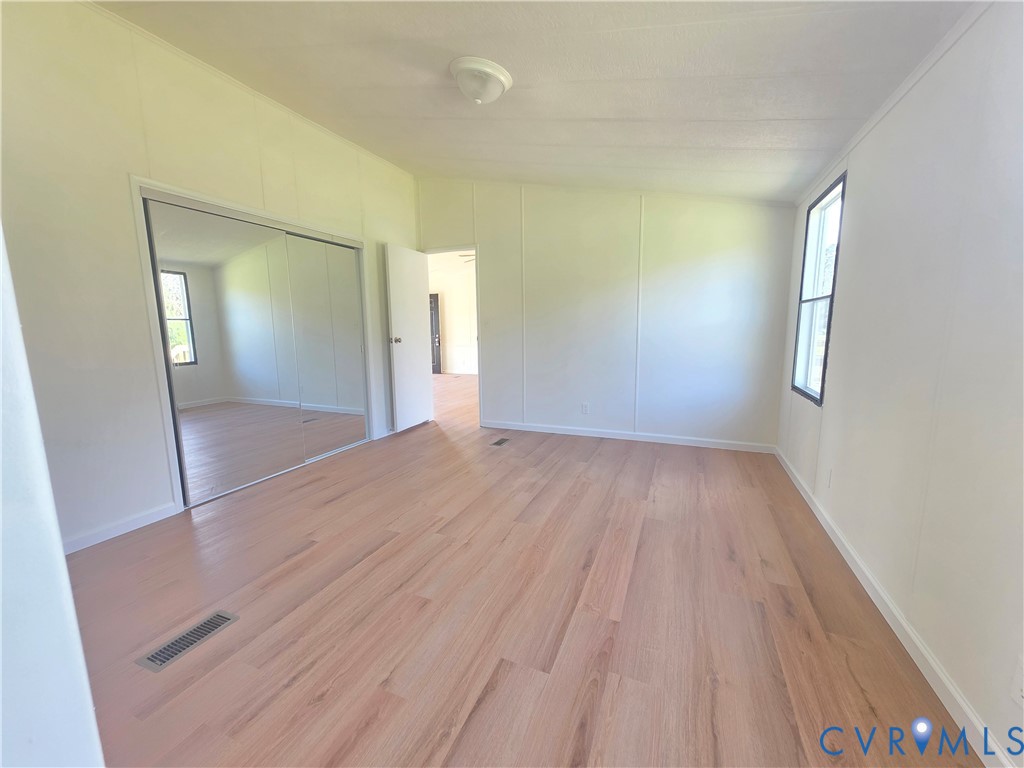 16808 Hamilton Arms Road Dewitt, VA 23840 - Photo 20 of 30 an empty room with wooden floor and windows