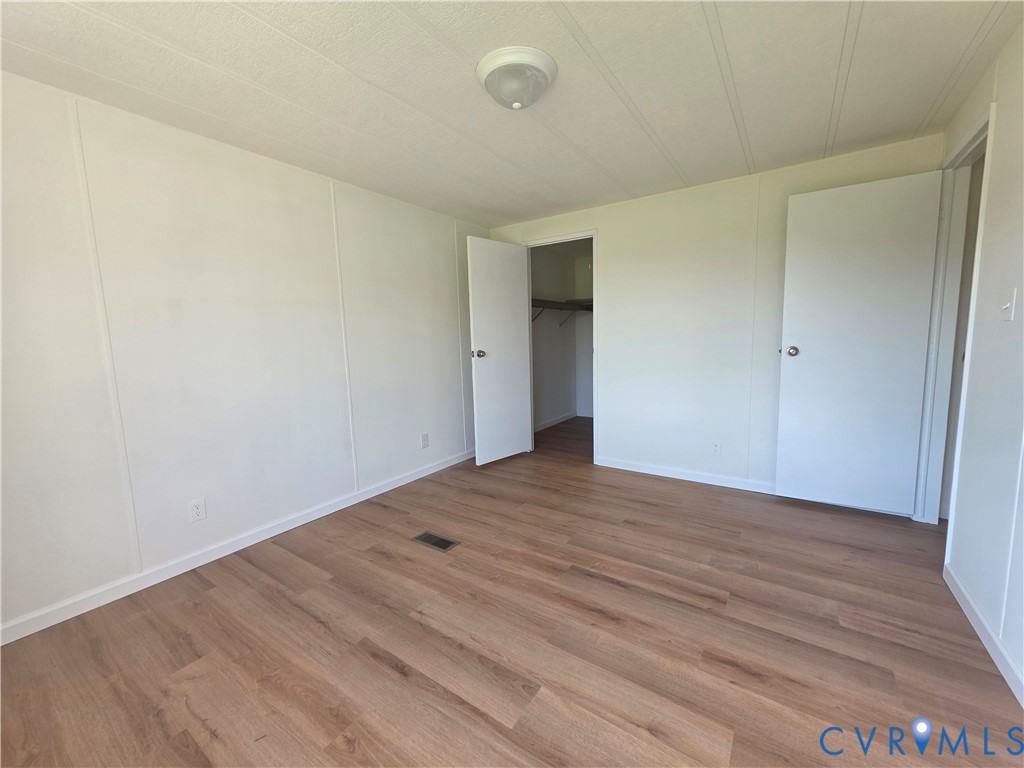 16808 Hamilton Arms Road Dewitt, VA 23840 - Photo 23 of 30 a view of empty room with wooden floor