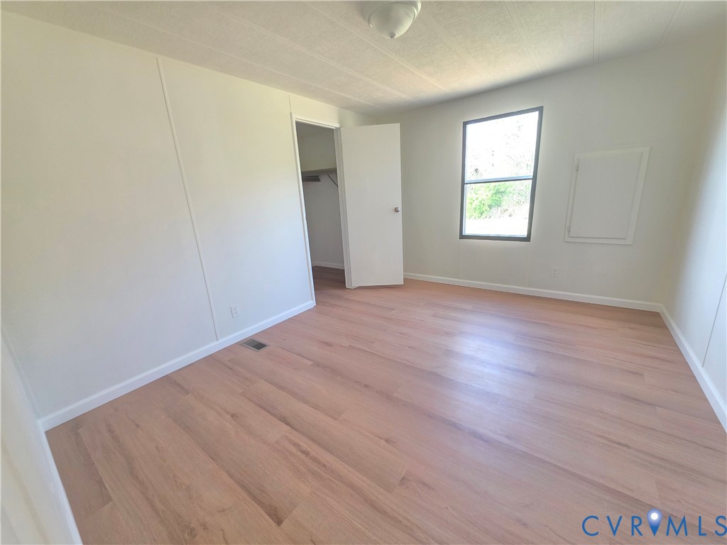 16808 Hamilton Arms Road Dewitt, VA 23840 - Photo 25 of 30 an empty room with wooden floor and windows