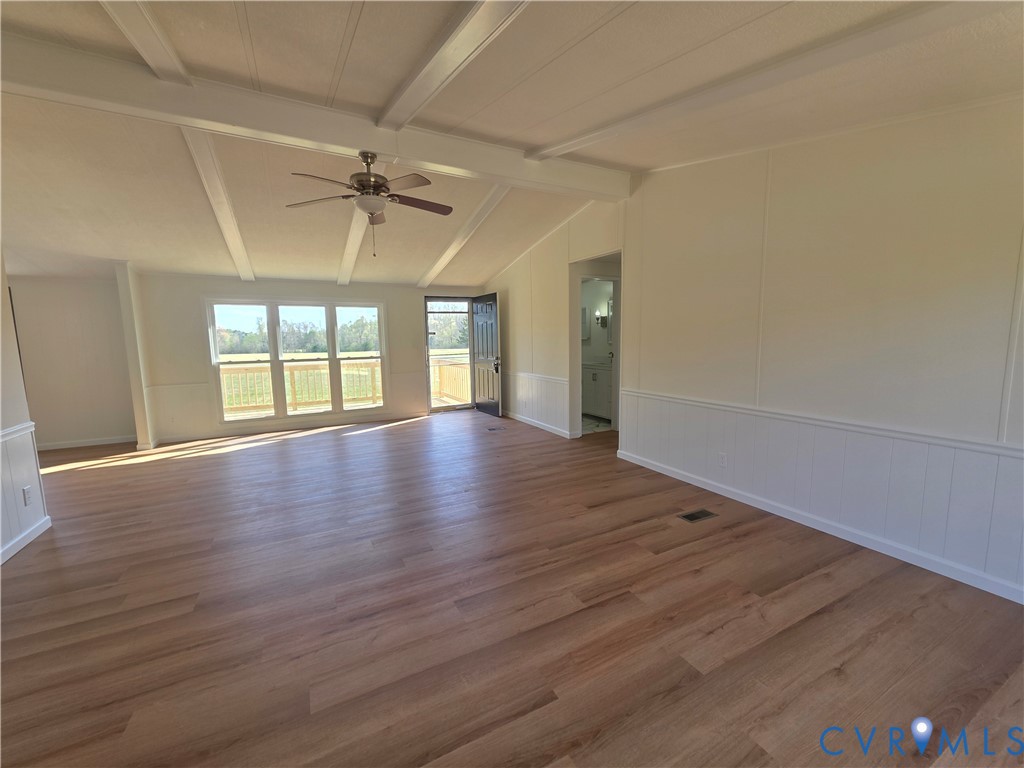 16808 Hamilton Arms Road Dewitt, VA 23840 - Photo 5 of 30 an empty room with wooden floor and windows