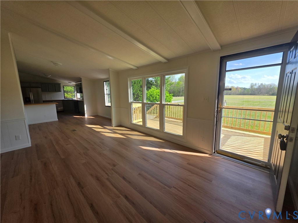 16808 Hamilton Arms Road Dewitt, VA 23840 - Photo 8 of 30 an empty room with wooden floor and windows