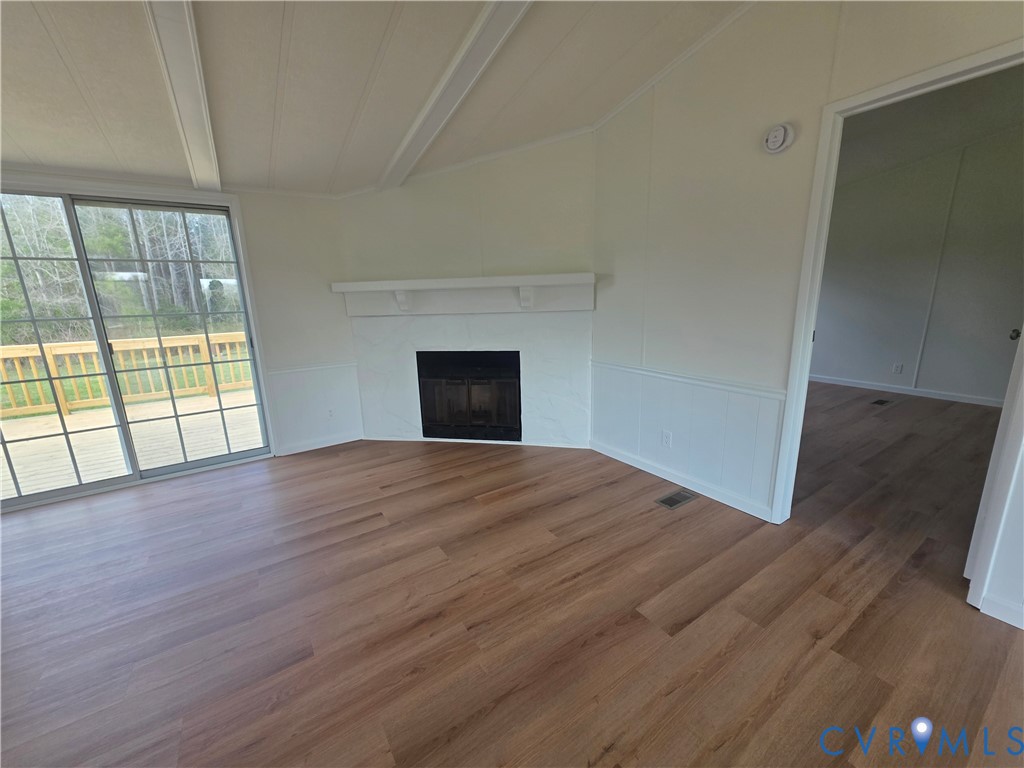16808 Hamilton Arms Road Dewitt, VA 23840 - Photo 9 of 30 an empty room with wooden floor and windows