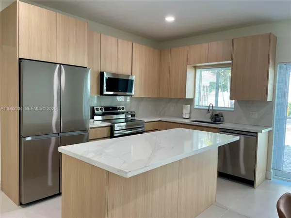 a kitchen with stainless steel appliances a refrigerator stove and microwave