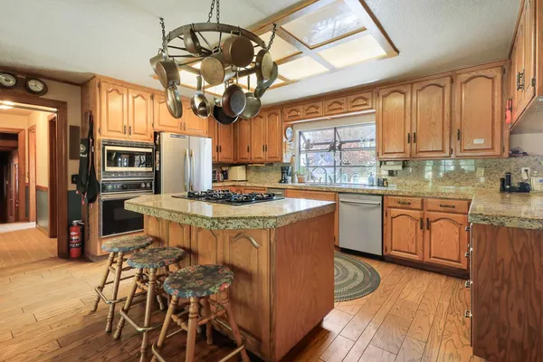 a kitchen that has a stove a sink and a refrigerator