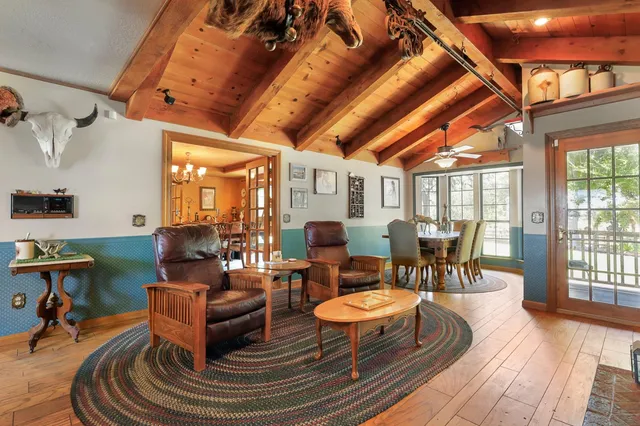 a living room with furniture and a chandelier