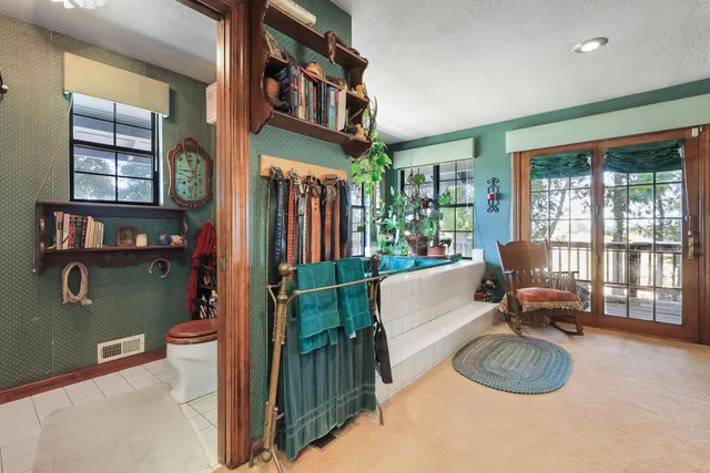 an aerial view of a house with balcony and trees al around