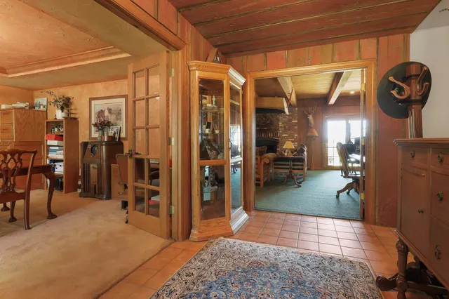 a living room with furniture a lamp and a rug