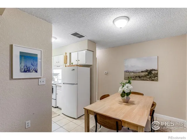 a kitchen with refrigerator and cabinets