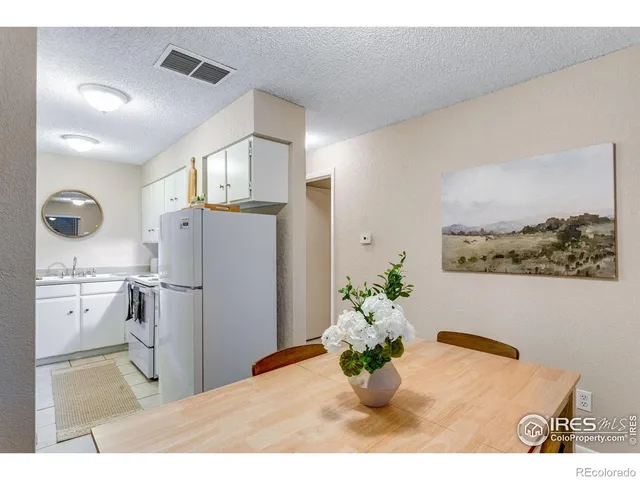 a kitchen with stainless steel appliances kitchen island granite countertop a refrigerator and a stove