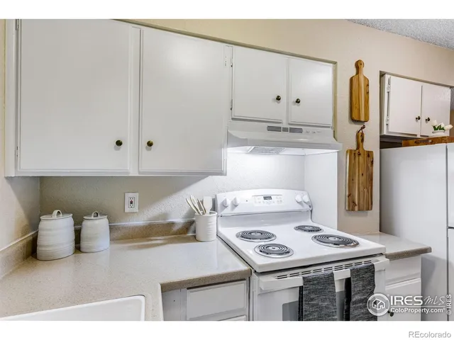 a kitchen with a stove and a refrigerator
