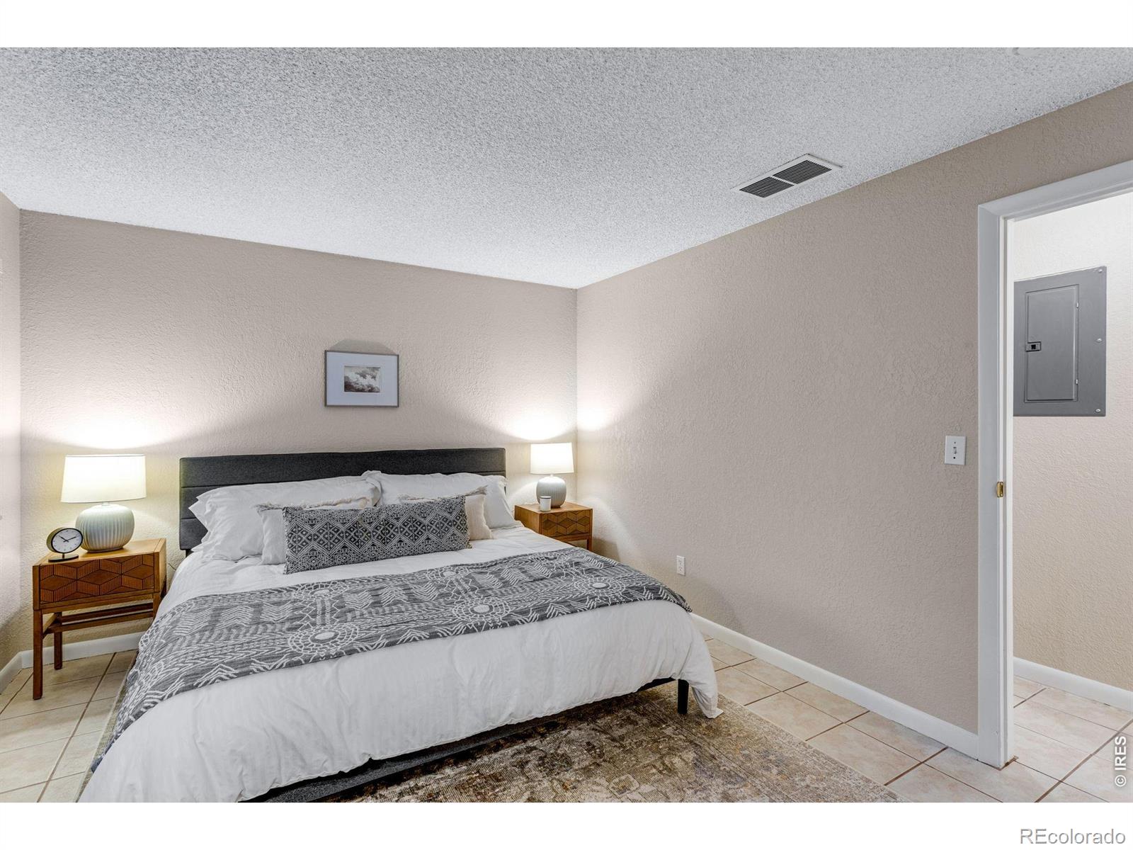 1705 Heatheridge Road Fort Collins, CO 80526 - Photo 16 of 21 a bedroom with a large bed and a lamp with window