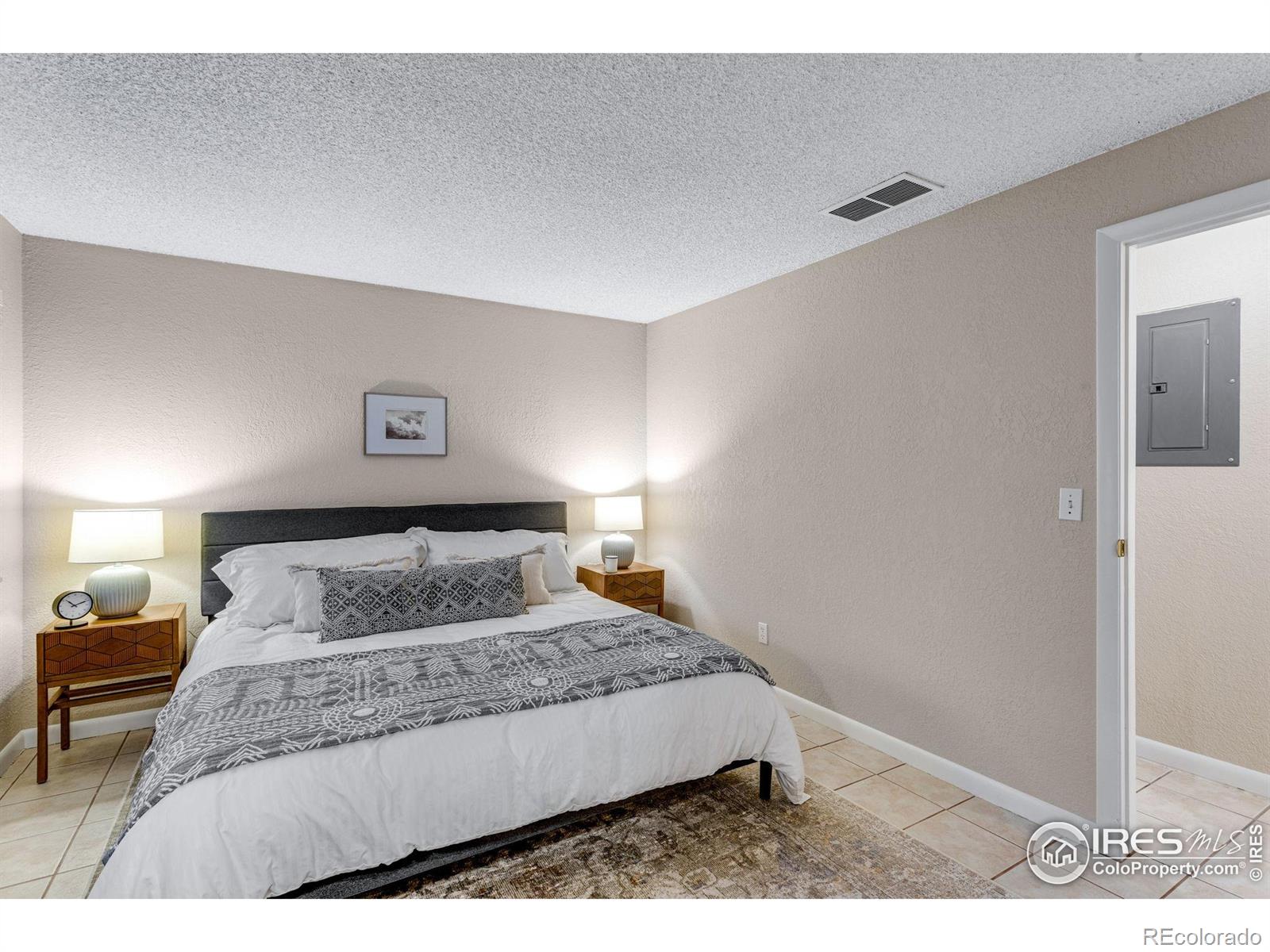 1705 Heatheridge Road Fort Collins, CO 80526 - Photo 17 of 21 a bedroom with a large bed and a lamp with window