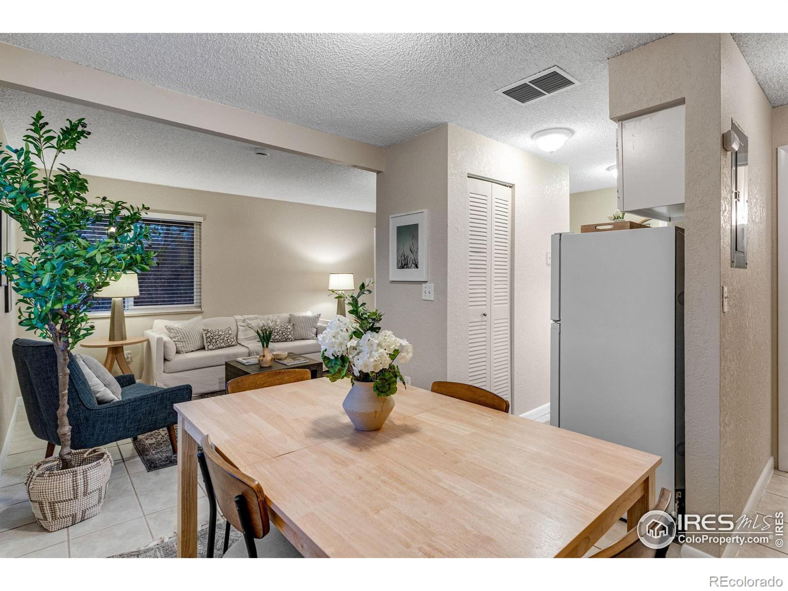 1705 Heatheridge Road Fort Collins, CO 80526 - Photo 6 of 21 a view of a dining room with furniture and a potted plant