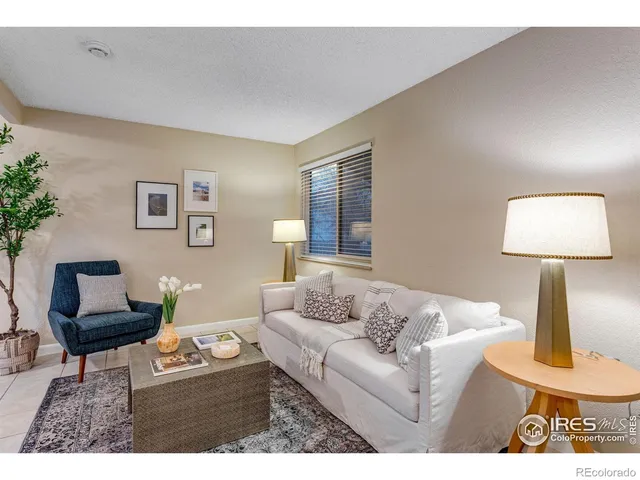 a living room with furniture and a lamp