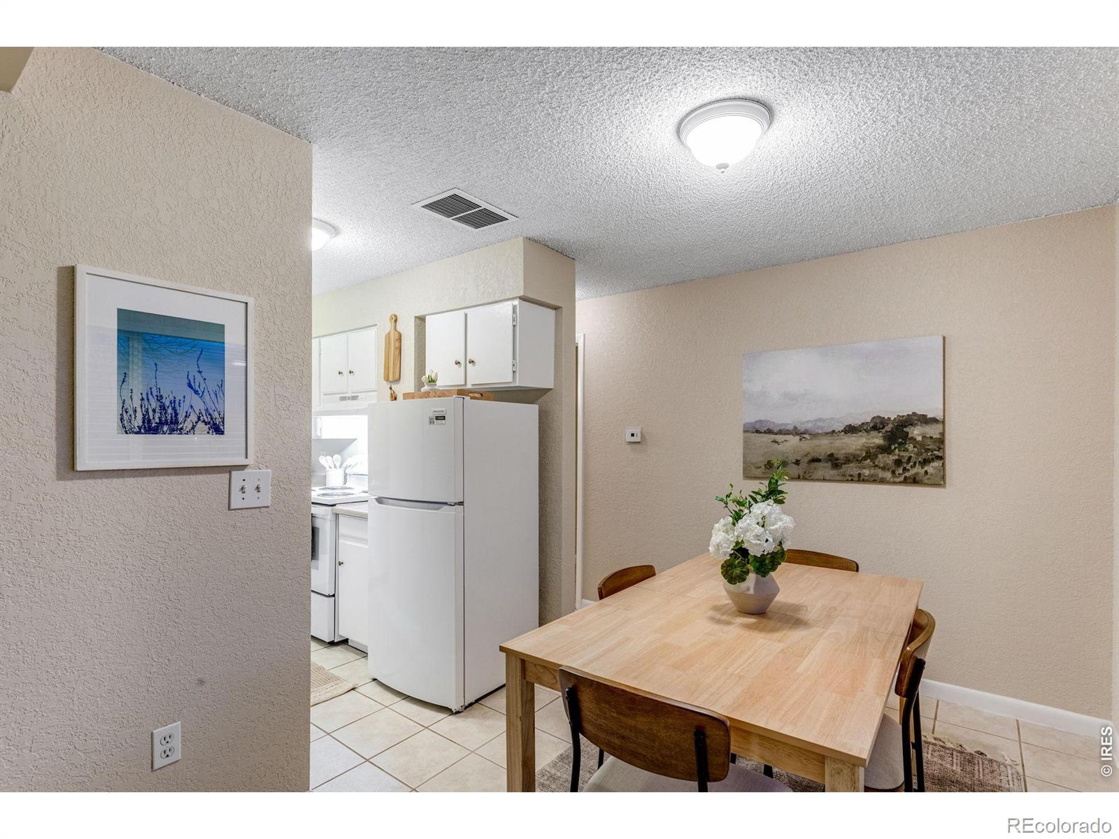 1705 Heatheridge Road Fort Collins, CO 80526 - Photo 7 of 21 a kitchen with refrigerator and cabinets