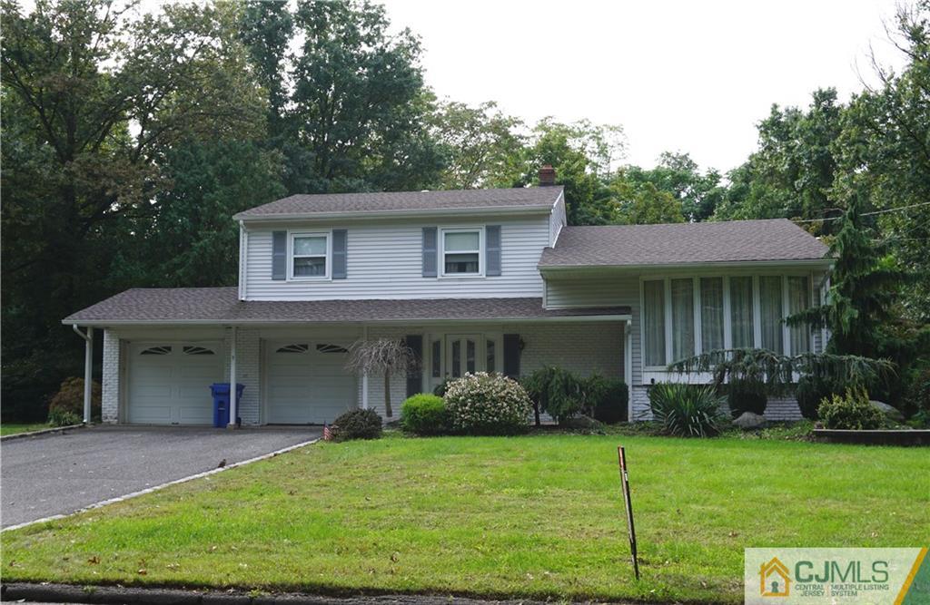 9 Ravine Drive Colonia, NJ 07067 - Photo 2 of 2 a front view of a house with garden