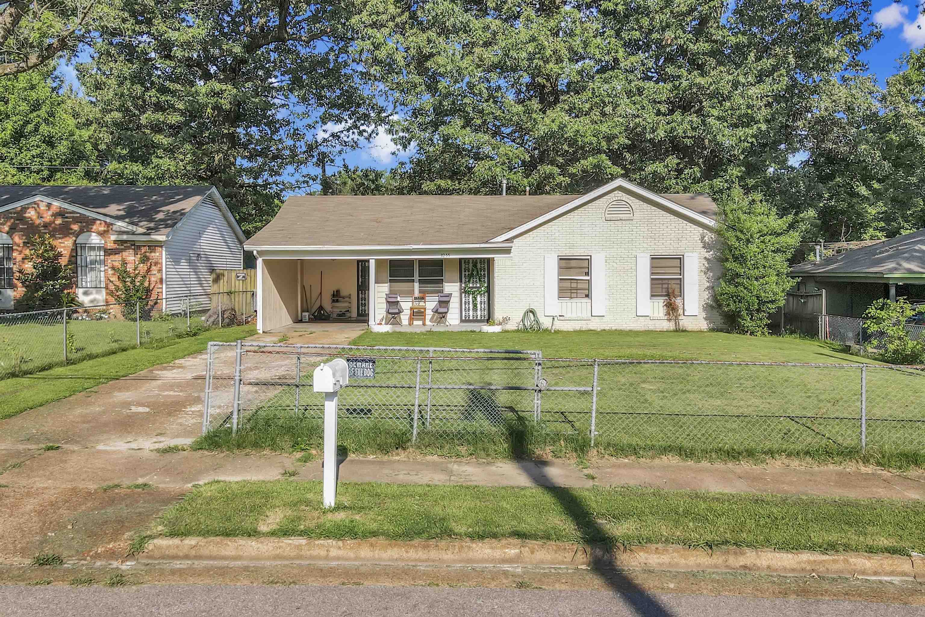 3255 Benjestown Road Memphis, TN 38127 - Photo 1 of 1 View of front of house featuring covered porch, a fenced front yard, an attached carport, and driveway