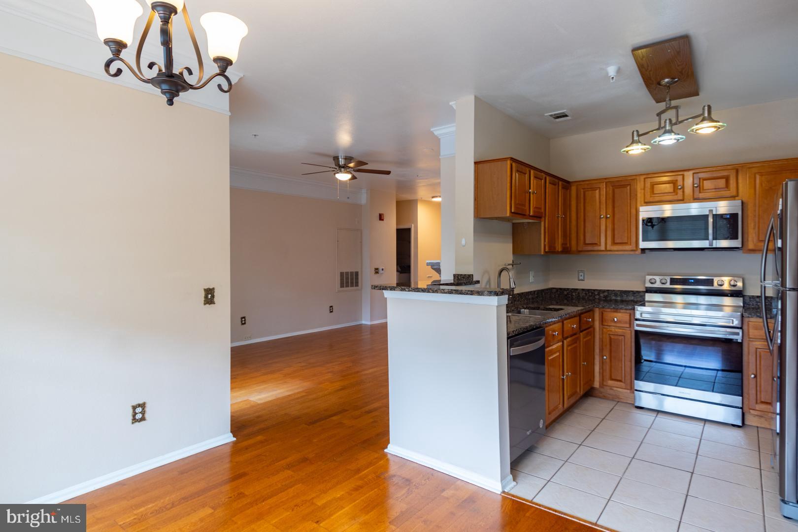 1600 Spring Gate Dr., Unit 2207 McLean, VA 22102 - Photo 8 of 32 a kitchen with stainless steel appliances granite countertop a stove a sink and a refrigerator