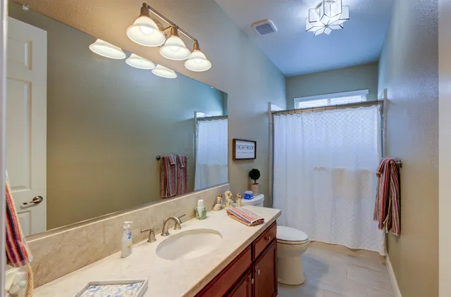 a bathroom with a sink double vanity and a mirror