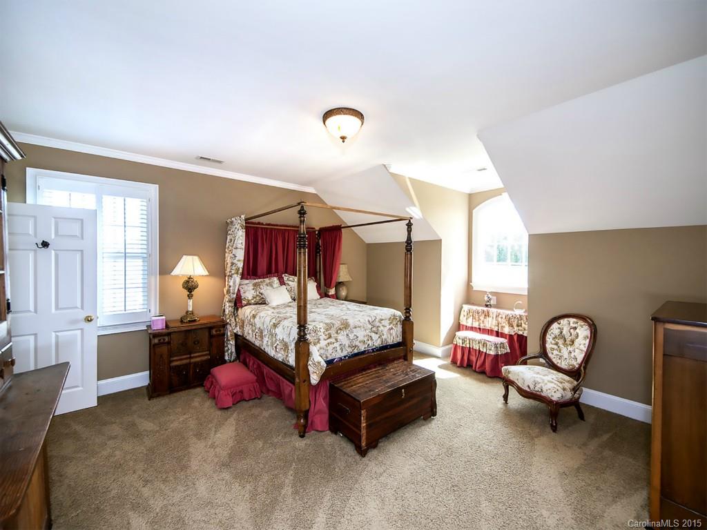 5029 Mobley Store Road McConnells, SC 29726 - Photo 12 of 24 a bedroom with a bed and a chandelier