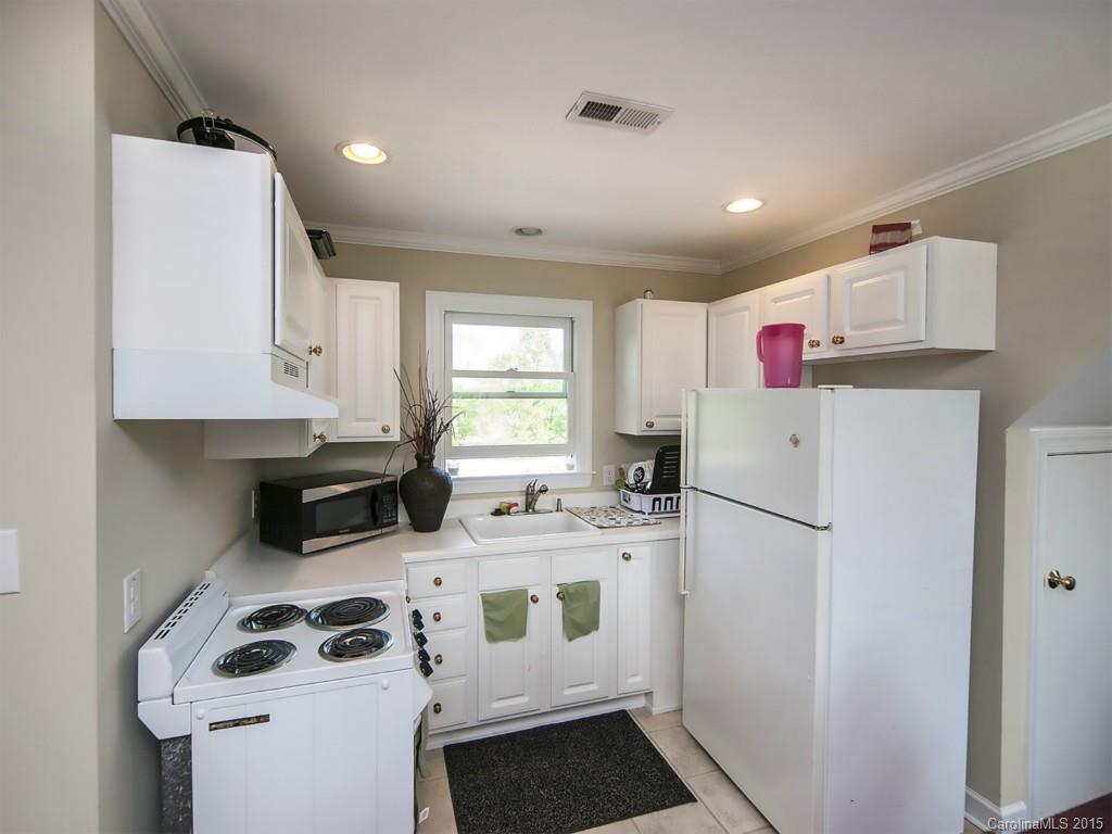 5029 Mobley Store Road McConnells, SC 29726 - Photo 13 of 24 a kitchen with stainless steel appliances a stove a refrigerator sink and cabinets