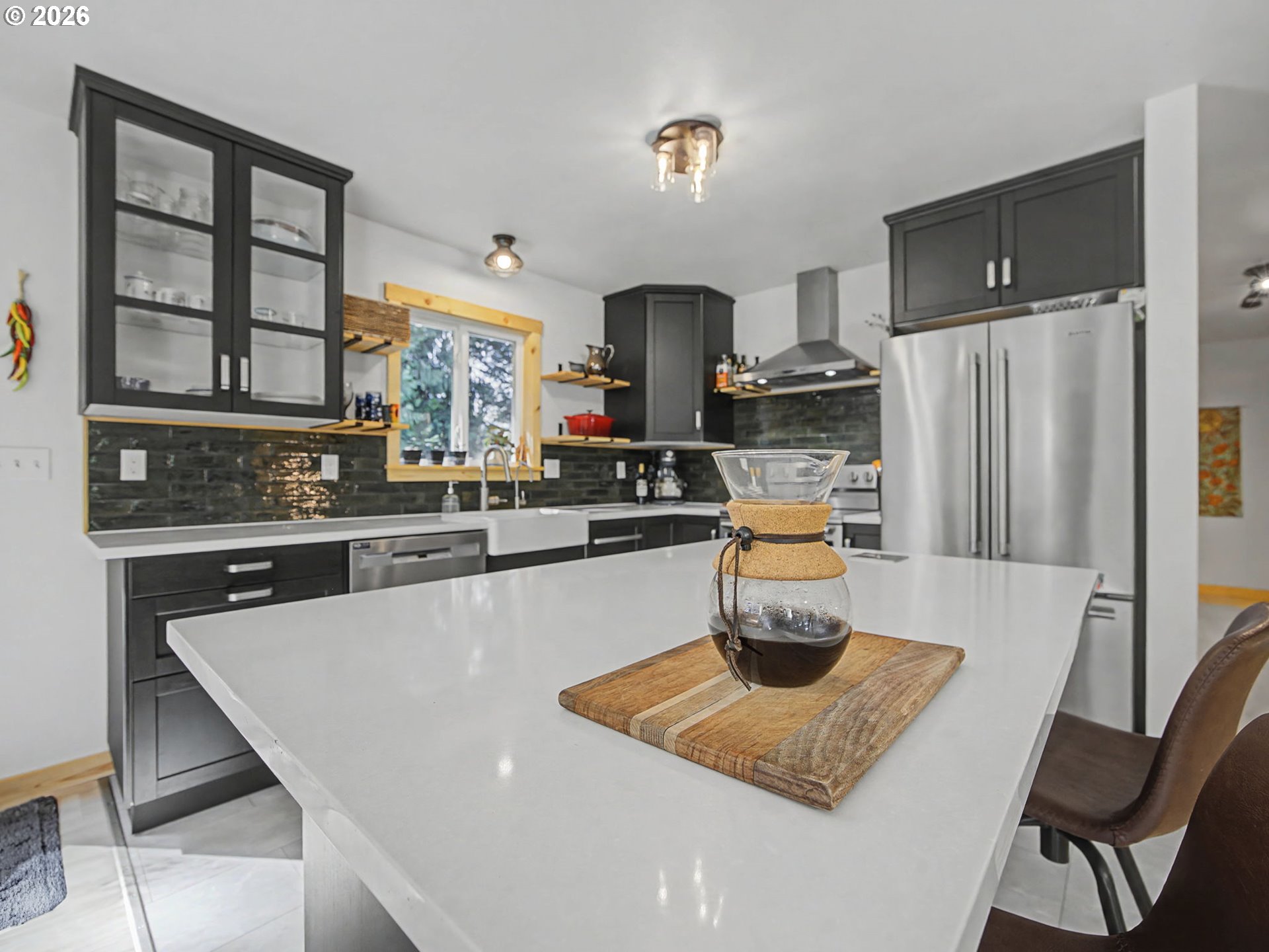 36036 Southeast Gunderson Road Sandy, OR 97055 - Photo 12 of 48 a kitchen with stainless steel appliances granite countertop a table chairs and a refrigerator